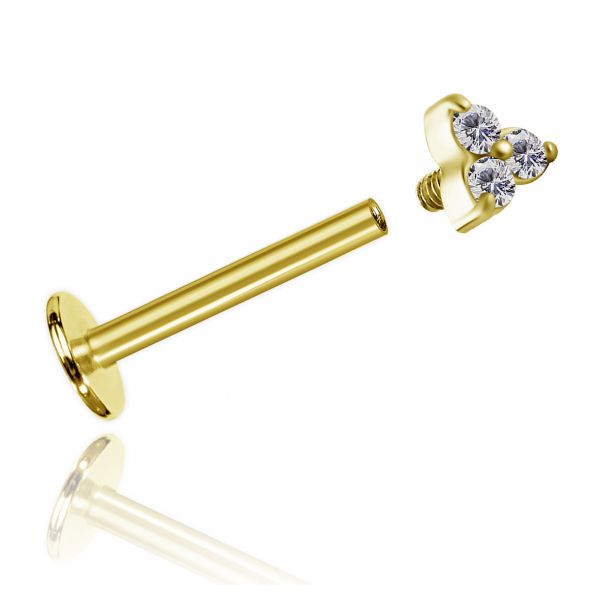 Golden labret piercing with three crystals
