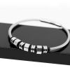 BRACELET EN ACIER AVEC ACCESSOIRES